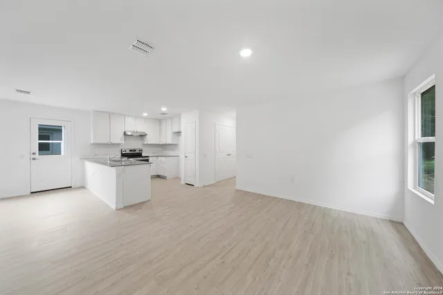 a view of kitchen with wooden floor and electronic appliances