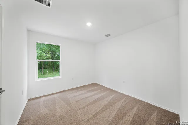 a view of a backyard with tree