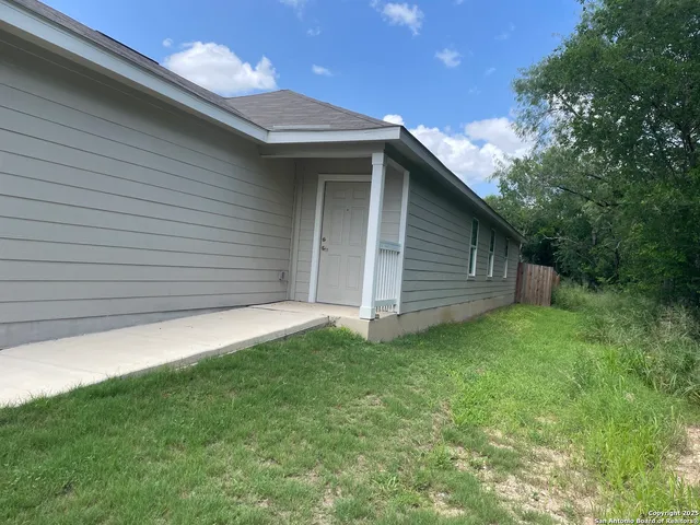 a backyard of a house with lots of green space