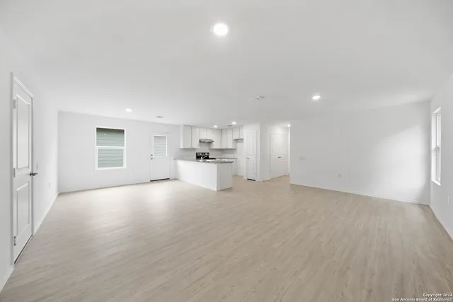 a view of a kitchen with a sink and a refrigerator