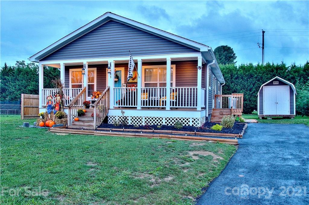 43 Janie Road, Unit 14 Clyde, NC 28721 - Photo 1 of 35 a front view of a house with a garden and deck