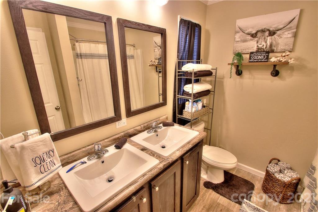 43 Janie Road, Unit 14 Clyde, NC 28721 - Photo 15 of 35 a bathroom with a sink toilet and mirror