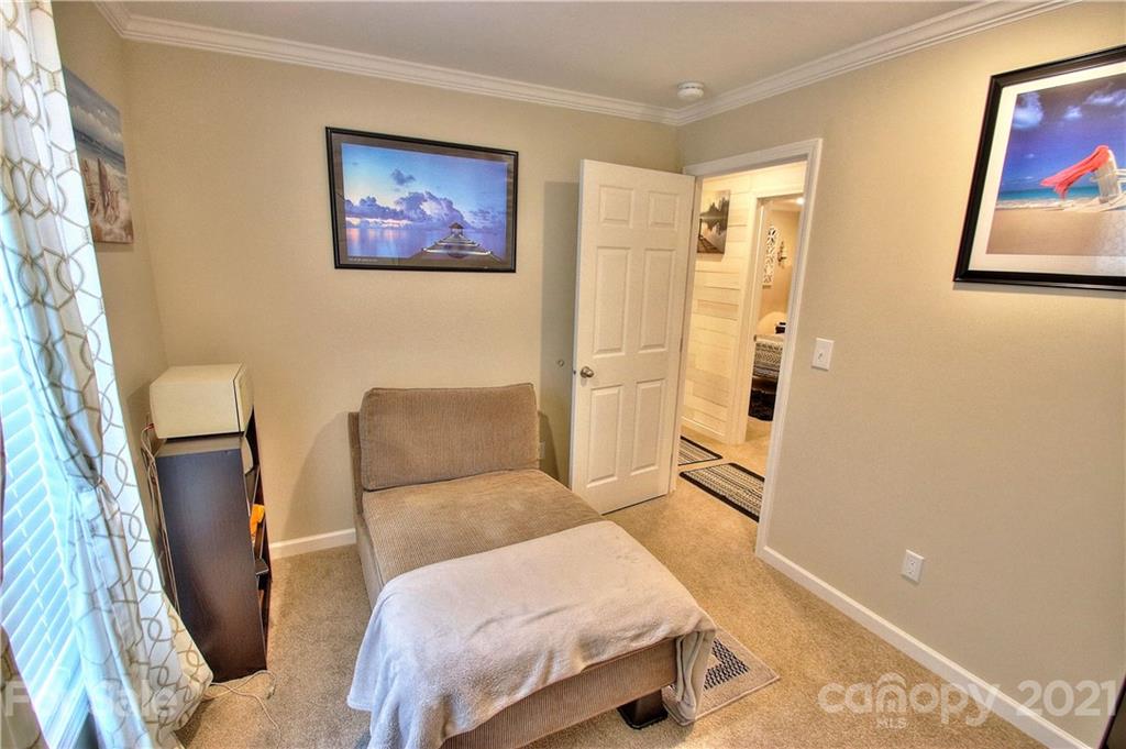 43 Janie Road, Unit 14 Clyde, NC 28721 - Photo 18 of 35 a bedroom with a bed and a painting on the wall