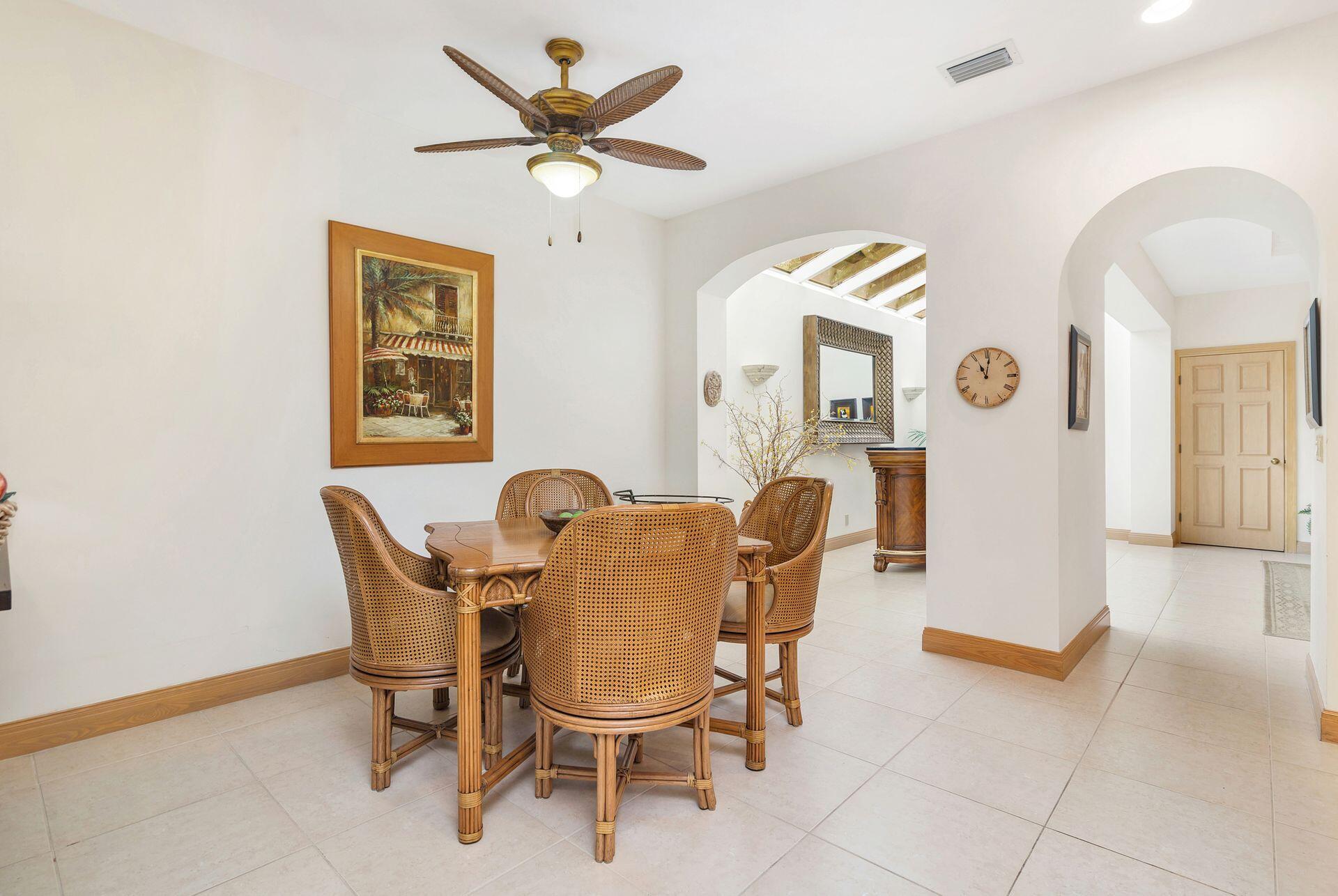 3330 Bridgegate Drive Jupiter, FL 33477 - Photo 14 of 39 a view of a dining room with furniture and a chandelier