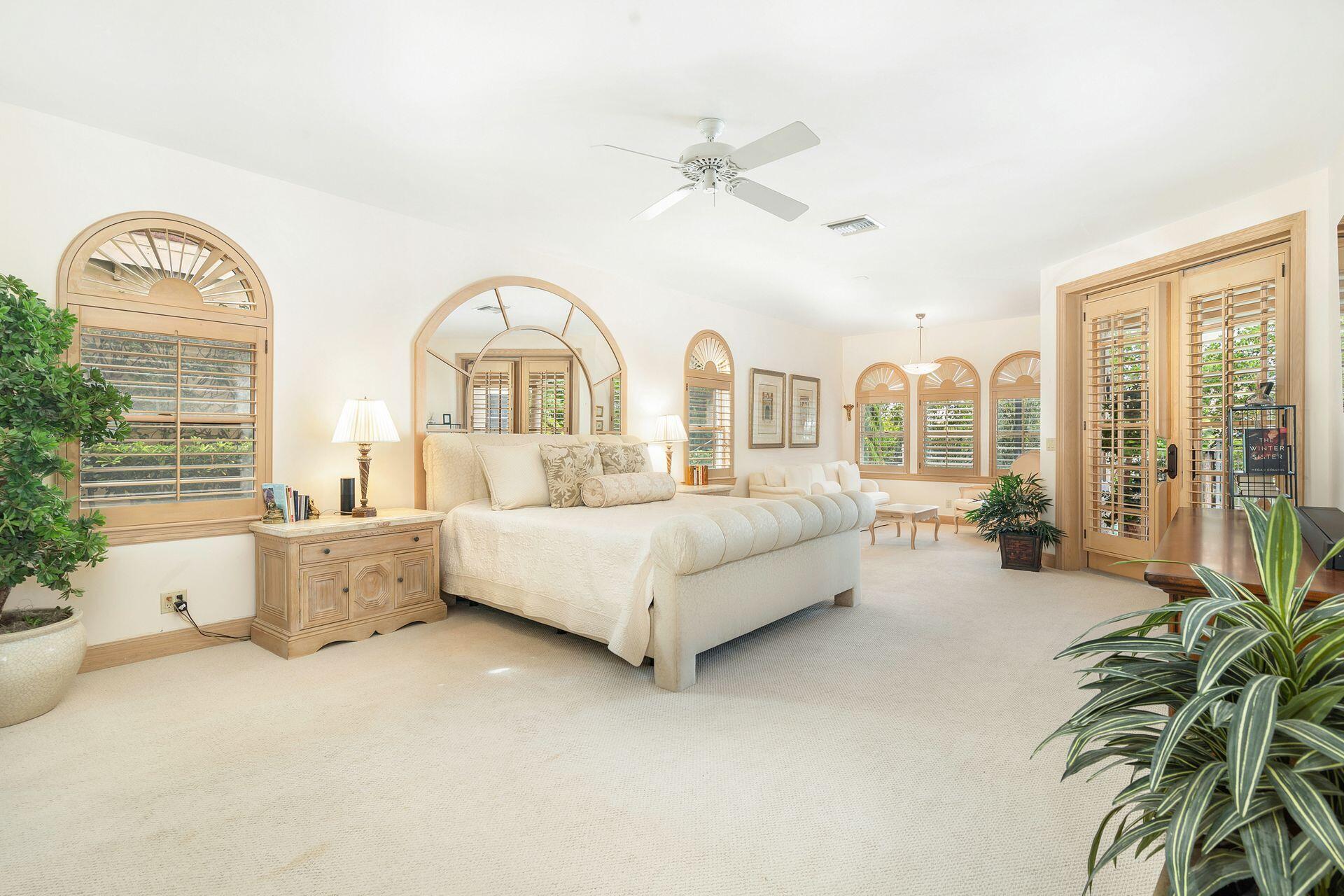 3330 Bridgegate Drive Jupiter, FL 33477 - Photo 18 of 39 a spacious bedroom with a bed and a large window