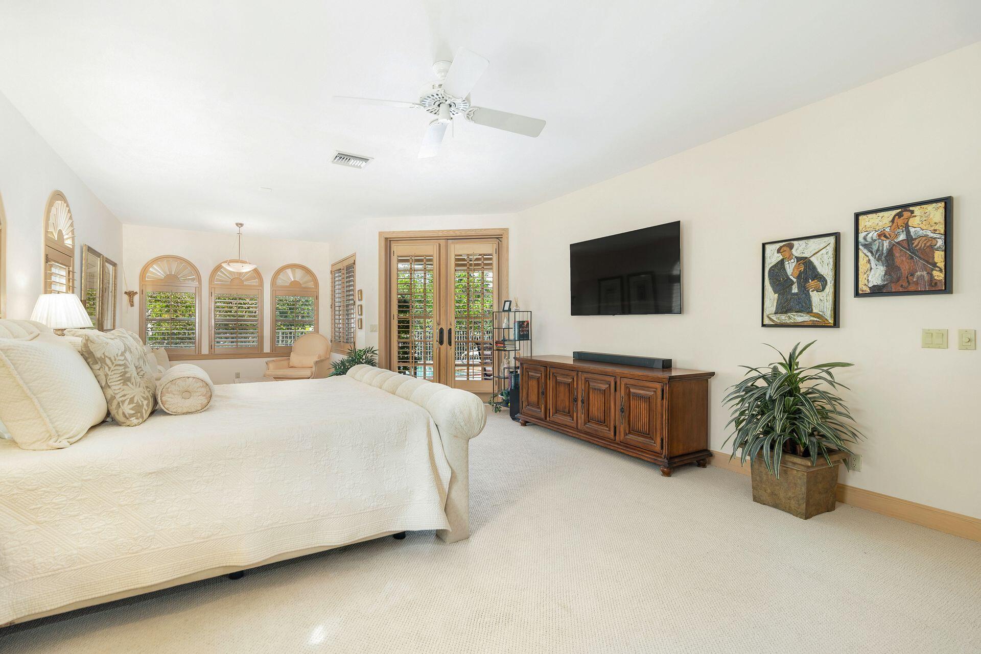 3330 Bridgegate Drive Jupiter, FL 33477 - Photo 19 of 39 a living room with furniture a flat screen tv and a large window