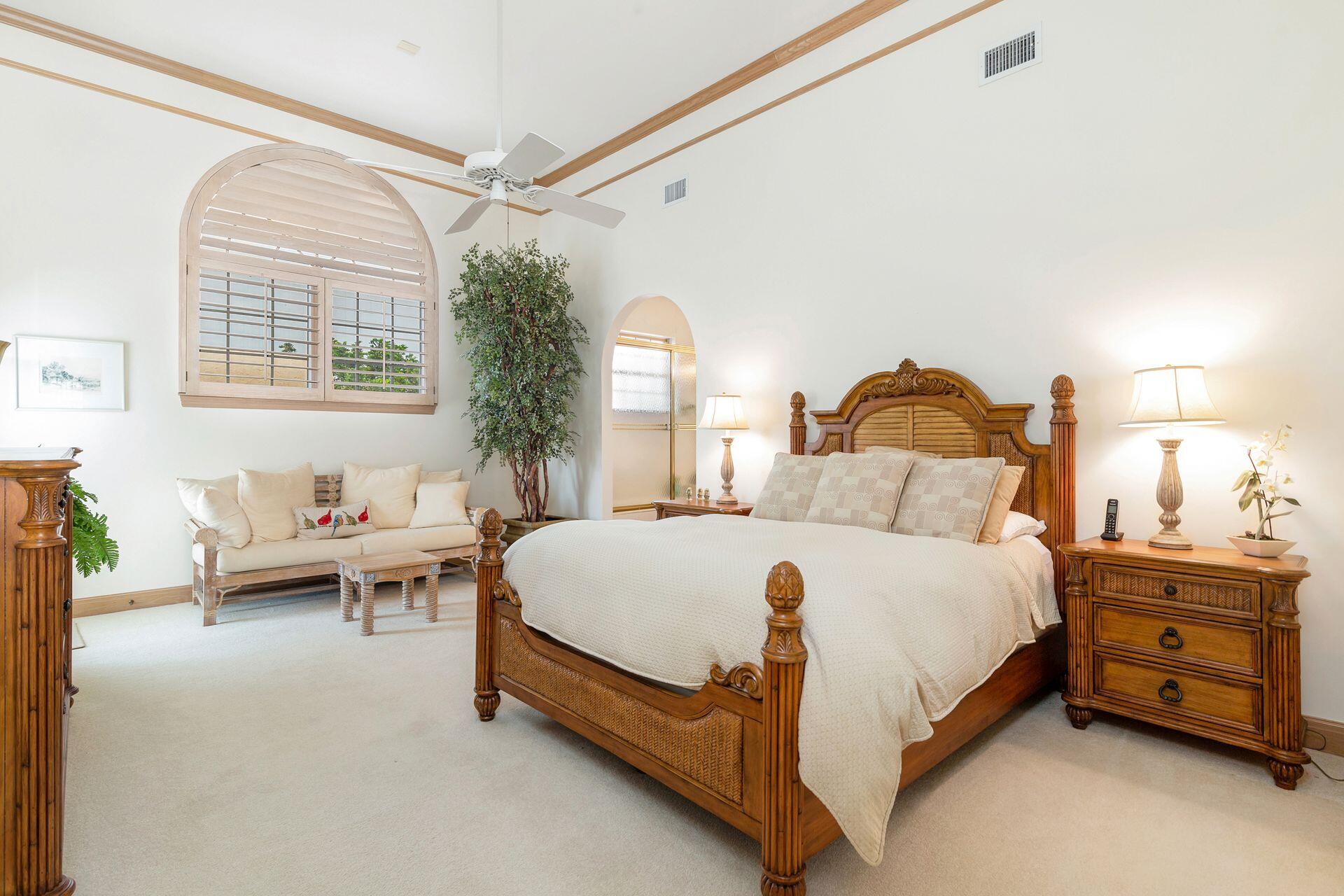 3330 Bridgegate Drive Jupiter, FL 33477 - Photo 26 of 39 a bedroom with a bed and a chandelier