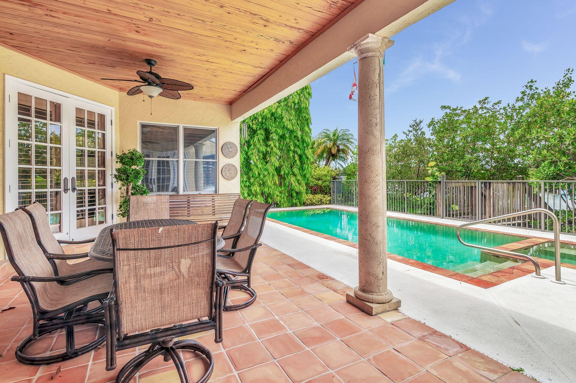 3330 Bridgegate Drive Jupiter, FL 33477 - Photo 30 of 39 a view of a patio with a table chairs and a yard