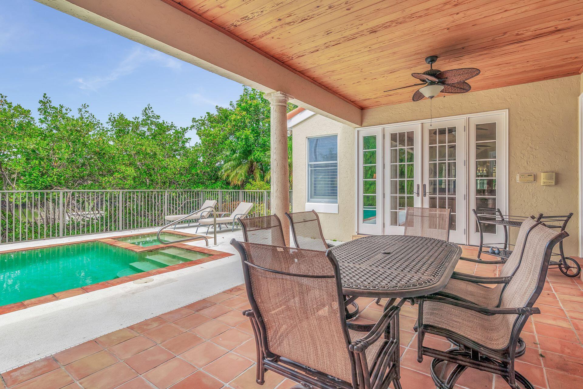 3330 Bridgegate Drive Jupiter, FL 33477 - Photo 31 of 39 a view of a patio with a table chairs and a table