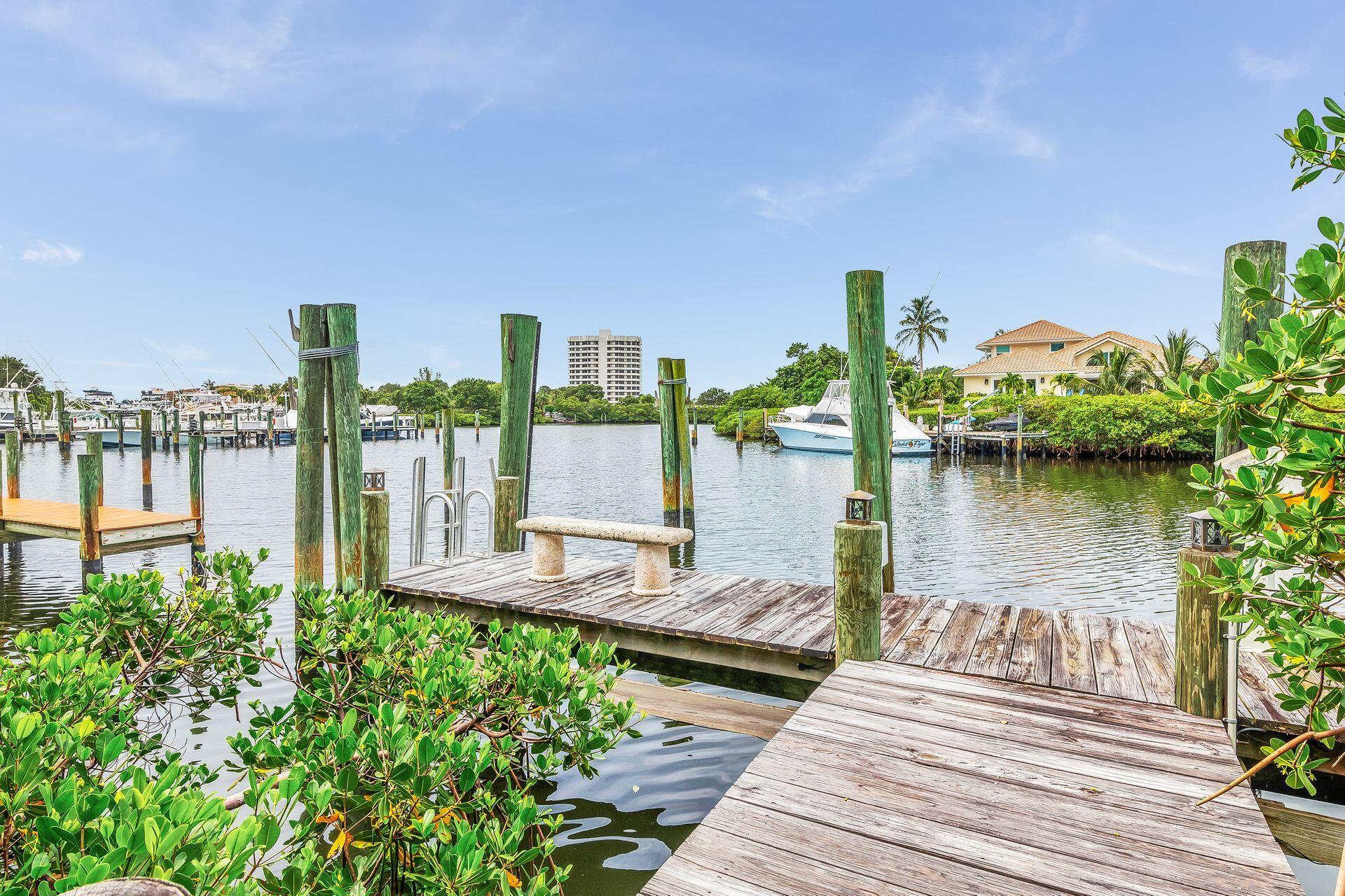 3330 Bridgegate Drive Jupiter, FL 33477 - Photo 34 of 39 a front view of a house with outdoor seating and lake view