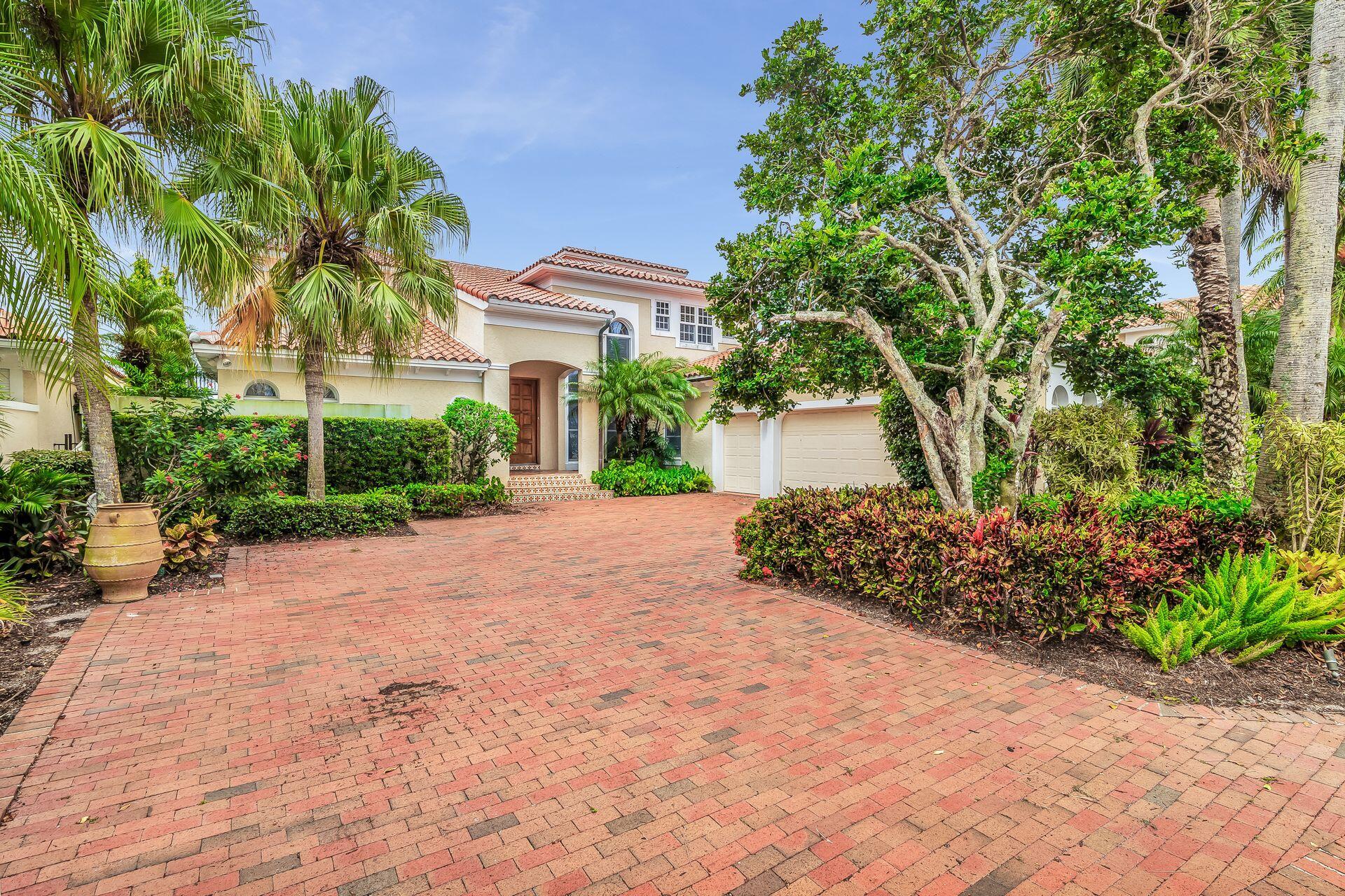 3330 Bridgegate Drive Jupiter, FL 33477 - Photo 38 of 39 a front view of a house with a yard and a garage