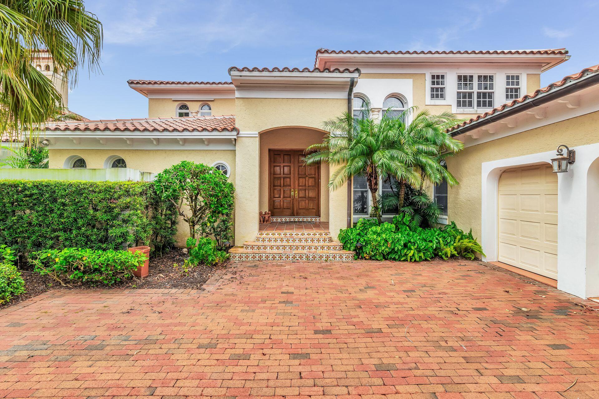 3330 Bridgegate Drive Jupiter, FL 33477 - Photo 4 of 39 a front view of a house with garden
