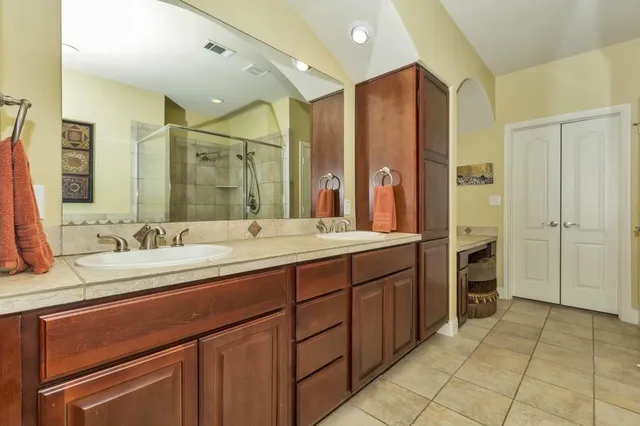 a bathroom with a double vanity sink and a mirror