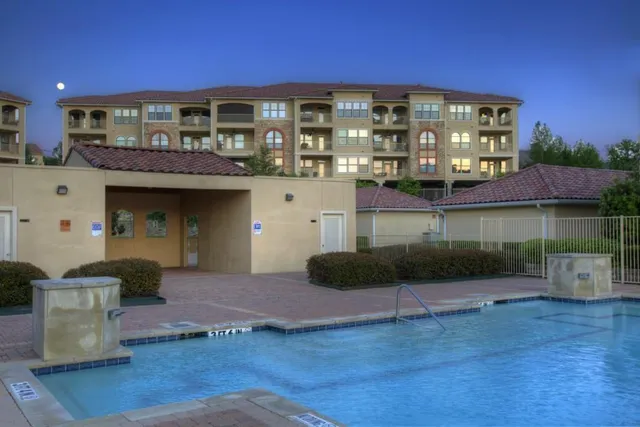 a front view of a building with a garden