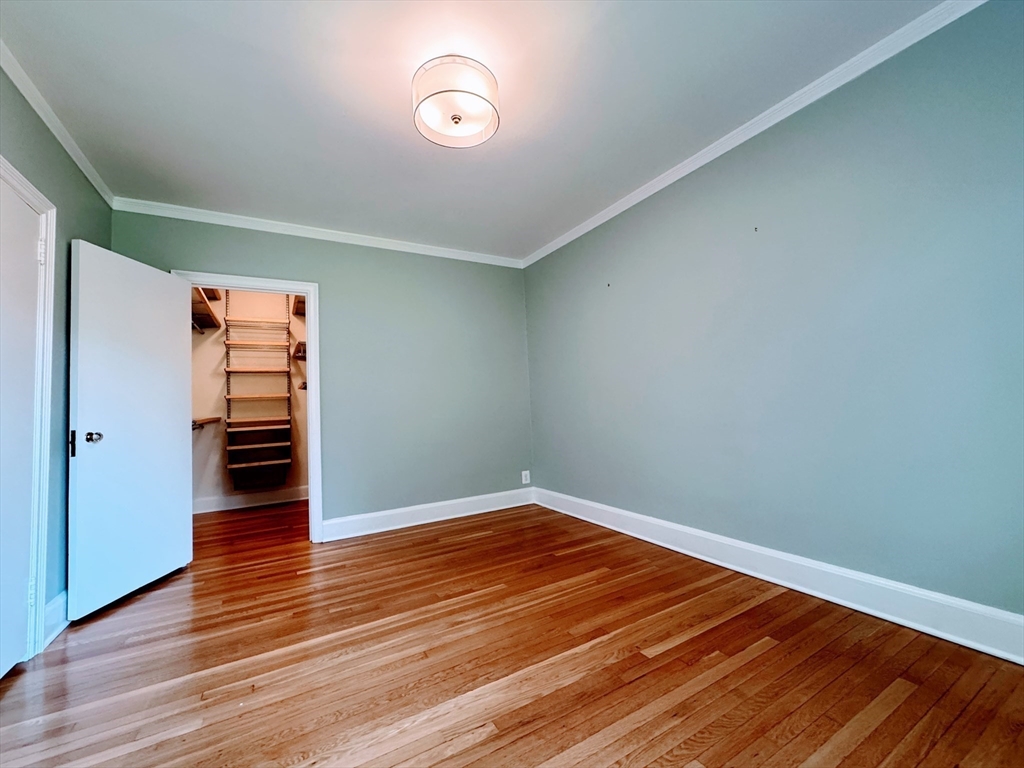 65 Strathmore Road, Unit 49 Boston, MA 02135 - Photo 12 of 26 a view of empty room with wooden floor