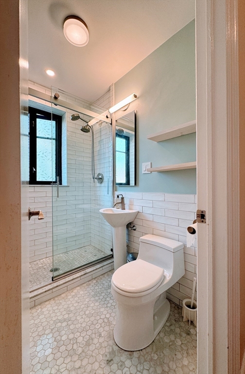 65 Strathmore Road, Unit 49 Boston, MA 02135 - Photo 17 of 26 a bathroom with a toilet sink and shower