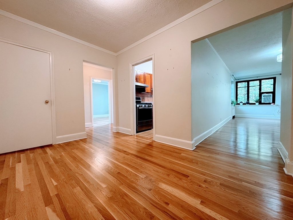 65 Strathmore Road, Unit 49 Boston, MA 02135 - Photo 2 of 26 a view of empty room with wooden floor