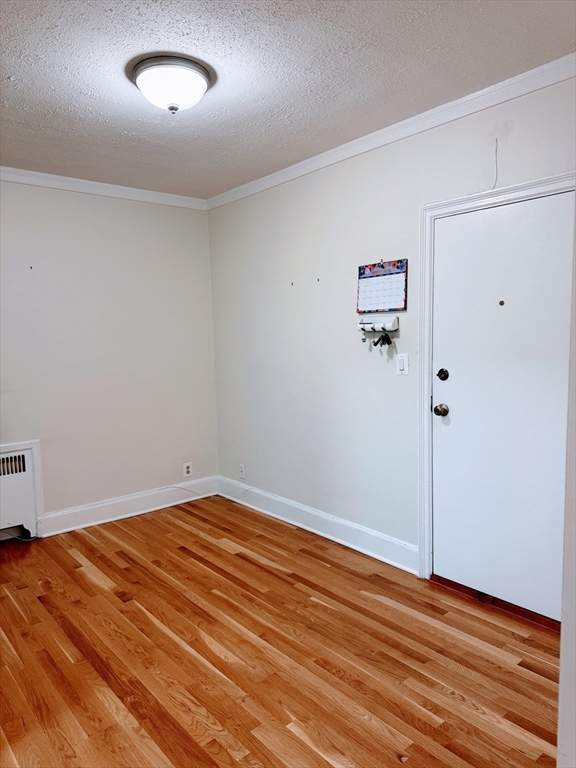 65 Strathmore Road, Unit 49 Boston, MA 02135 - Photo 3 of 26 an empty room with wooden floor and window