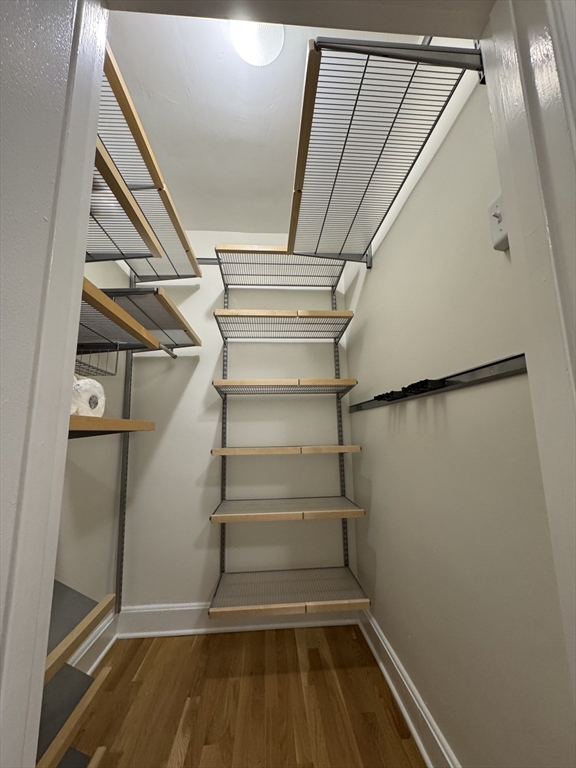 65 Strathmore Road, Unit 49 Boston, MA 02135 - Photo 5 of 26 a view of walk in closet with empty racks