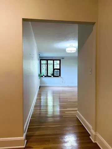 a view of a hallway with wooden floor