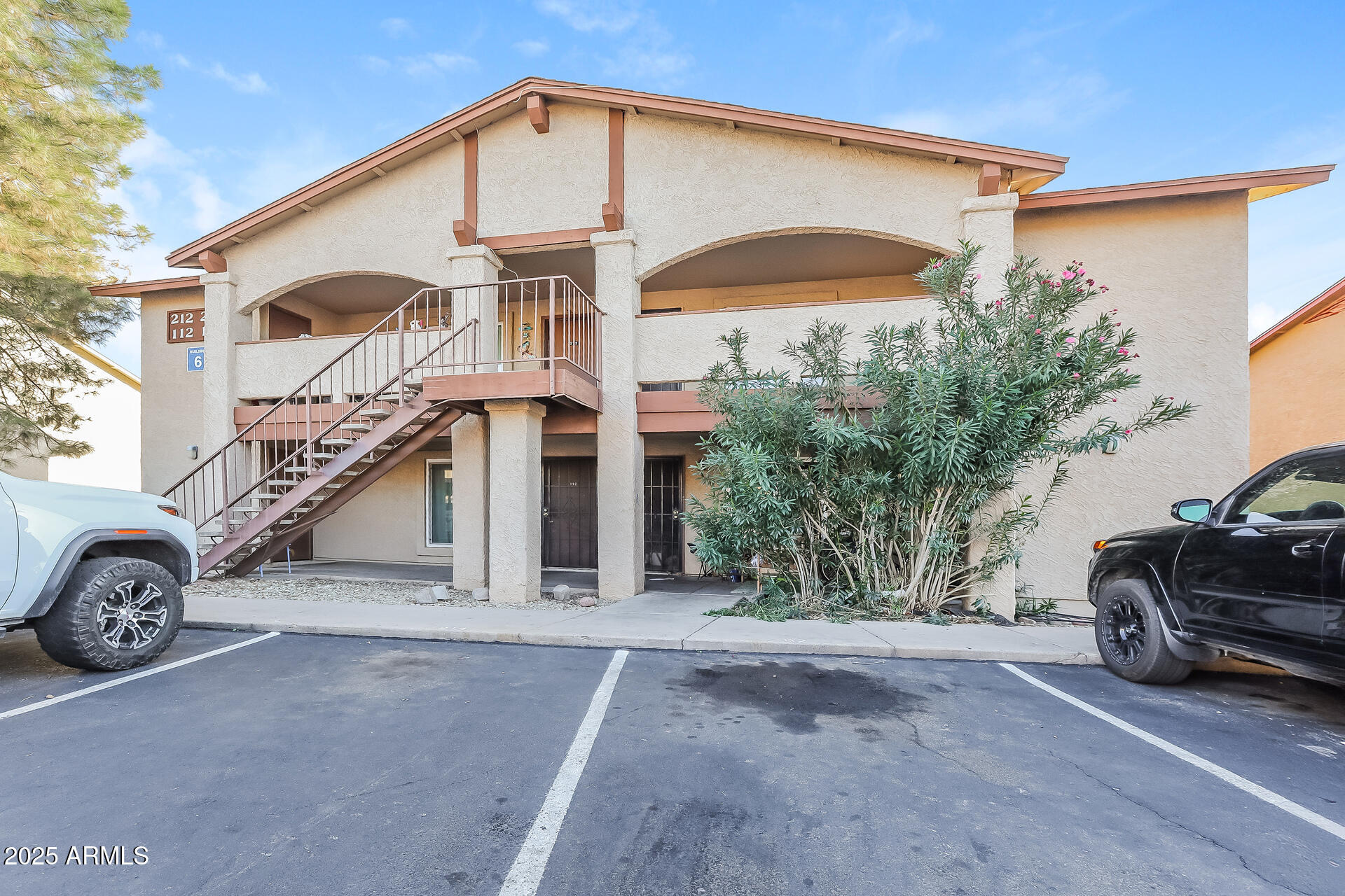 465 West Ivyglen Street, Unit 211 Mesa, AZ 85201 - Photo 1 of 16 a view of a car in front of a house