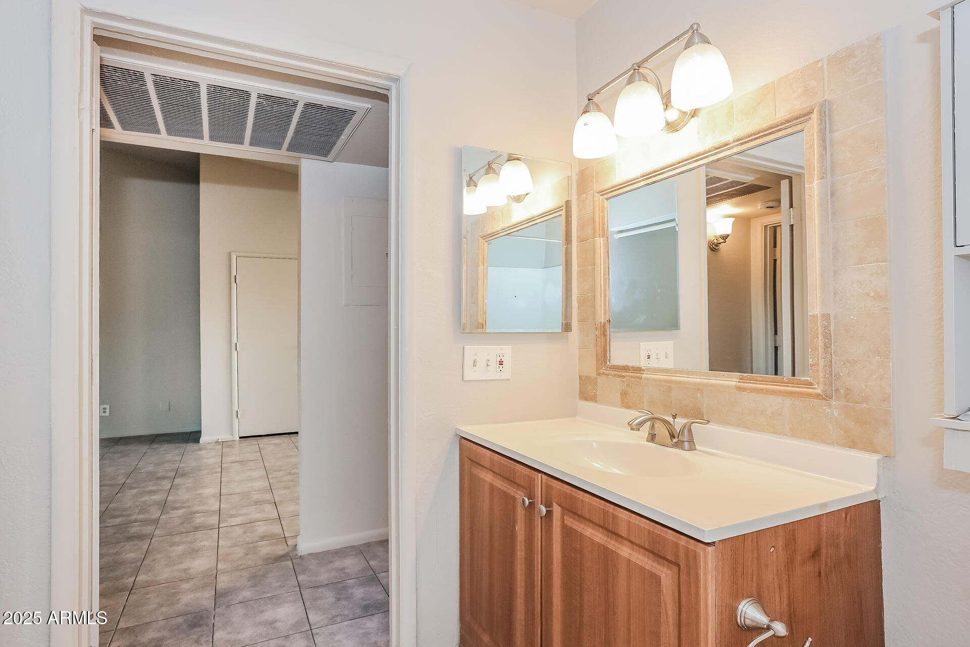 465 West Ivyglen Street, Unit 211 Mesa, AZ 85201 - Photo 12 of 16 a bathroom with a sink vanity and a mirror