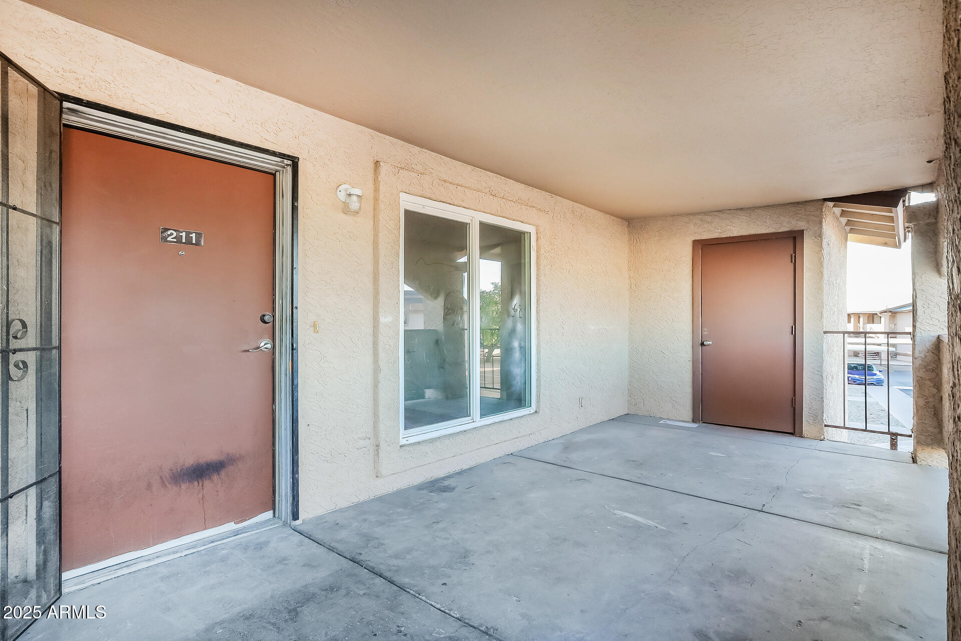 465 West Ivyglen Street, Unit 211 Mesa, AZ 85201 - Photo 2 of 16 an empty room with windows and entrance