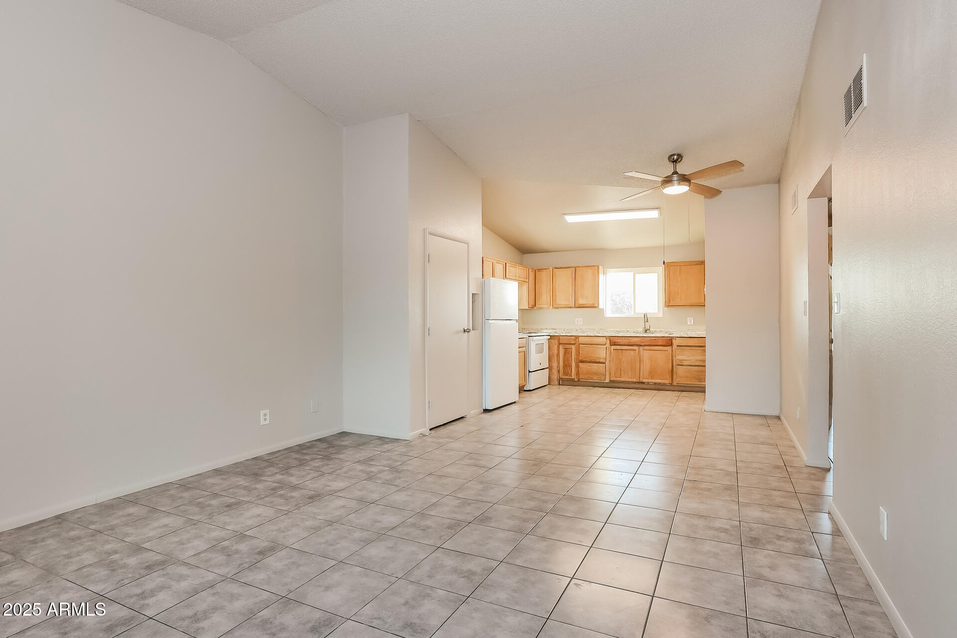 465 West Ivyglen Street, Unit 211 Mesa, AZ 85201 - Photo 4 of 16 a view of a kitchen with a sink and a refrigerator