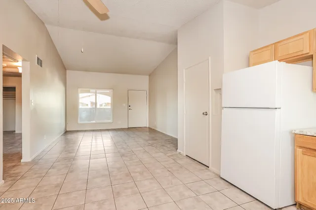 a view of a kitchen with a sink and a refrigerator