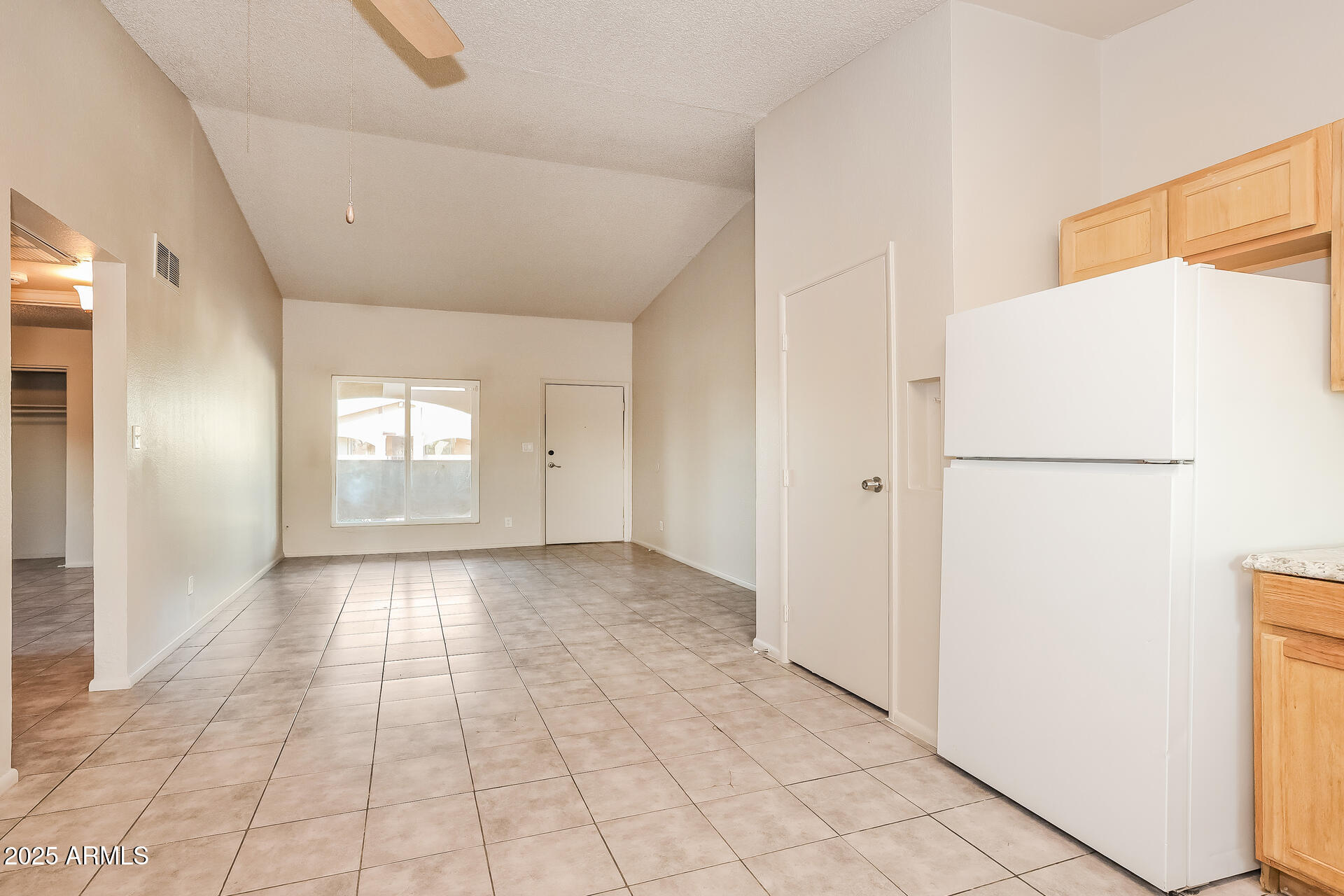 465 West Ivyglen Street, Unit 211 Mesa, AZ 85201 - Photo 5 of 16 a view of a livingroom with a refrigerator