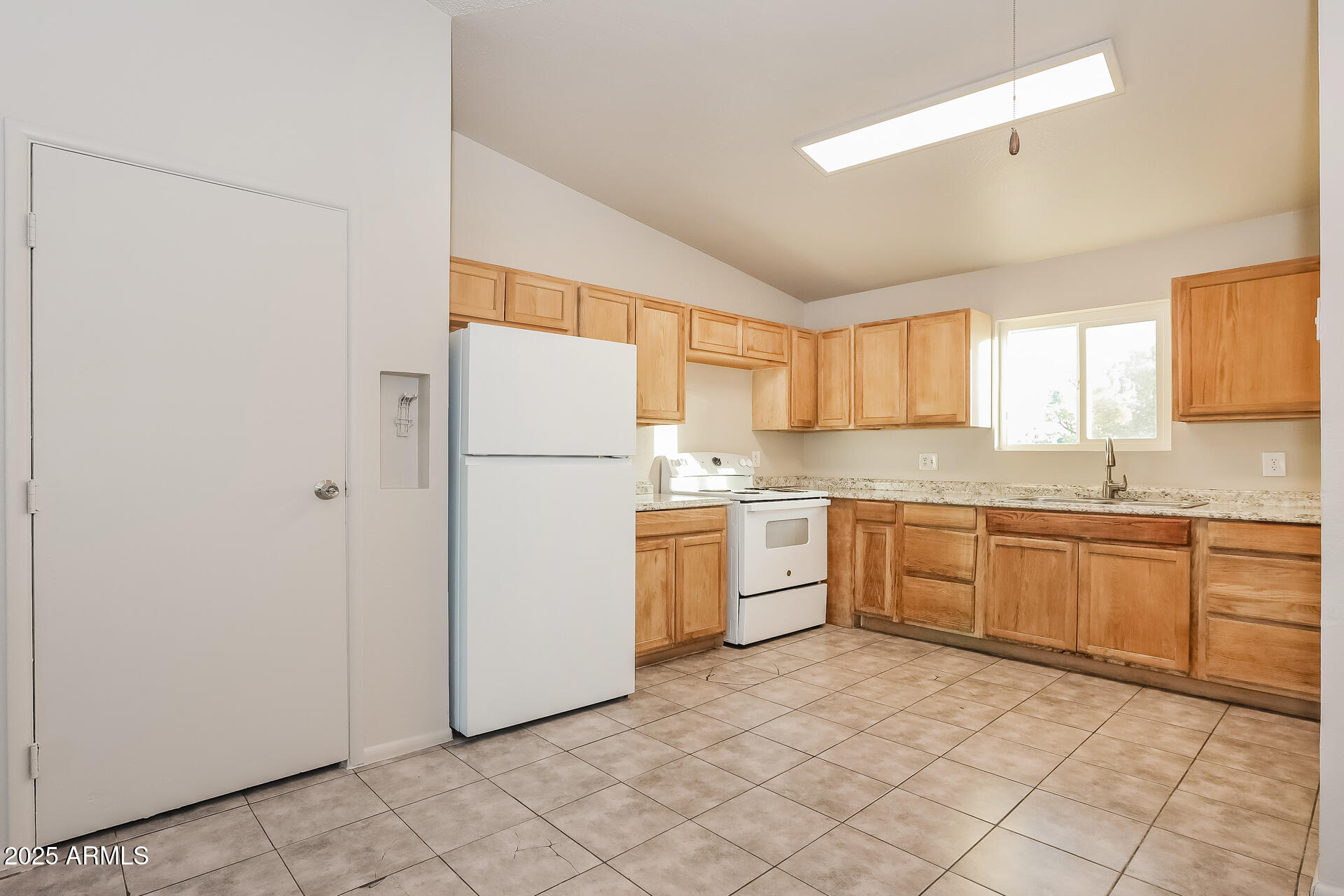 465 West Ivyglen Street, Unit 211 Mesa, AZ 85201 - Photo 6 of 16 a kitchen with a refrigerator sink and cabinets