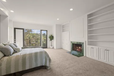a spacious bedroom with a bed and a fireplace