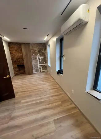 a view of a livingroom with wooden floor and staircase