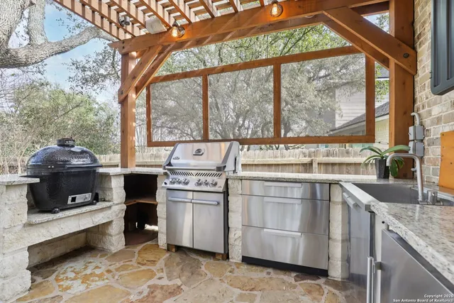 a kitchen with stainless steel appliances granite countertop a stove and a sink