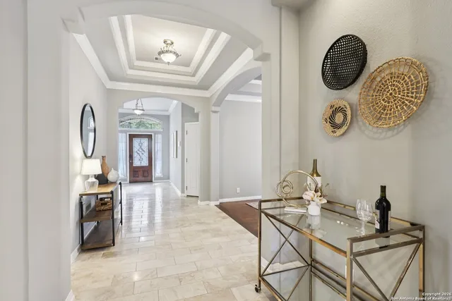 a view of a hallway with entryway wooden floor and dining table