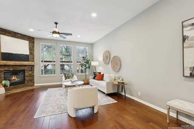 a living room with furniture a fireplace and a flat screen tv