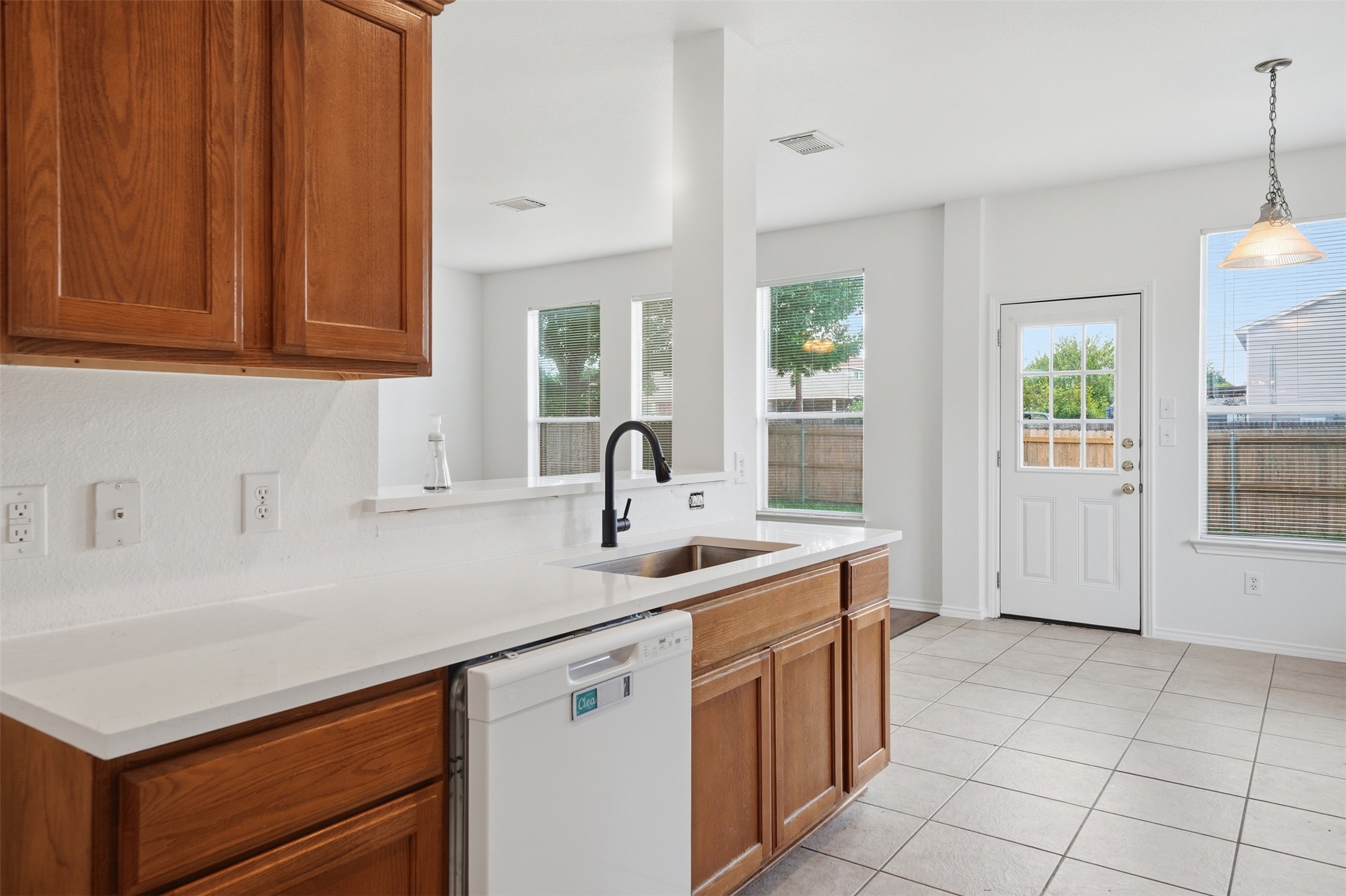 118 Invierno Street Kyle, TX 78640 - Photo 11 of 37 A well-lit kitchen with sleek countertops and abundant natural light.