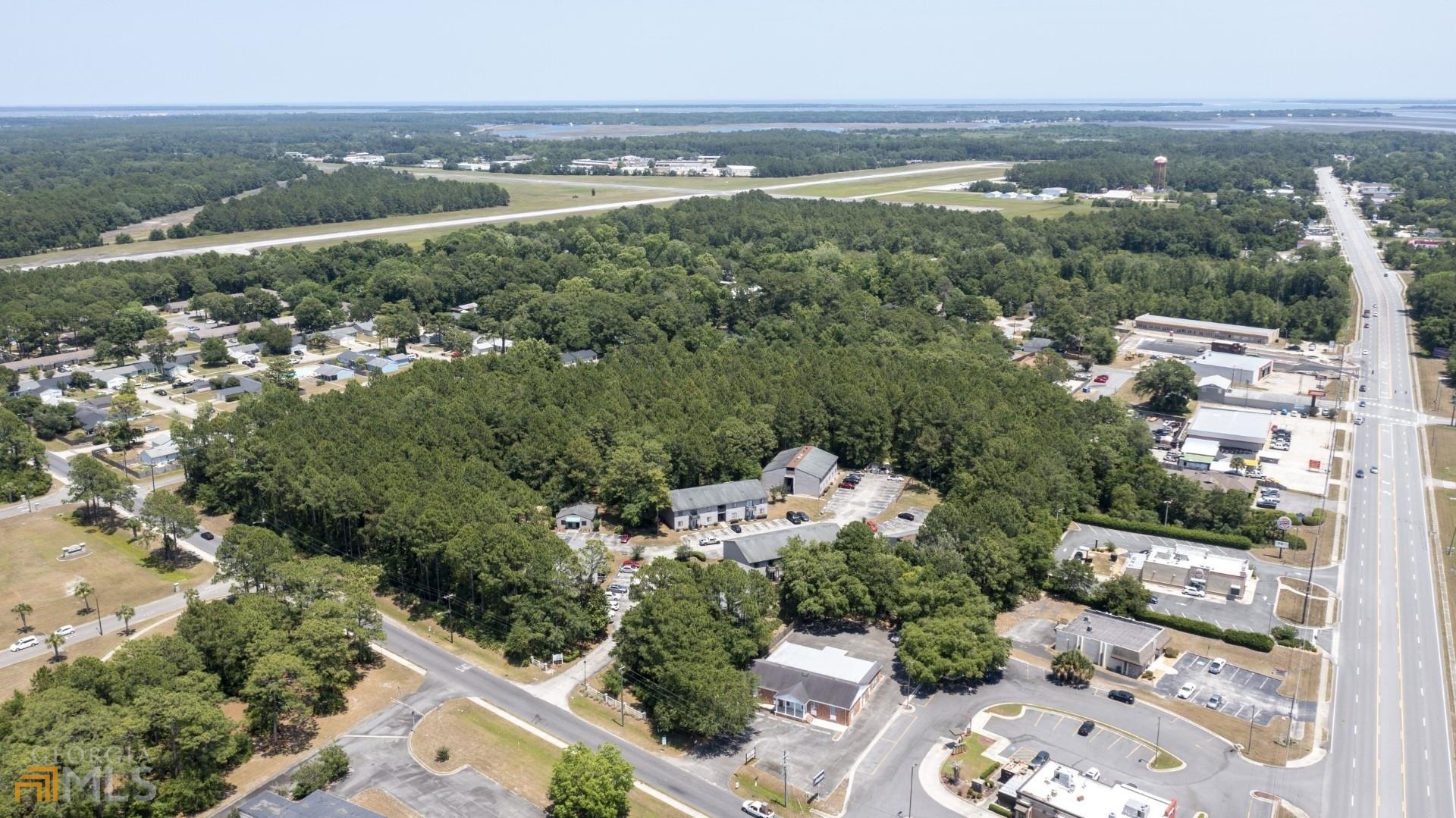 0 G - U Pelican Point Kings Bay, GA 31558 - Photo 2 of 19 an aerial view of a city with lots of residential buildings ocean and mountain view in back