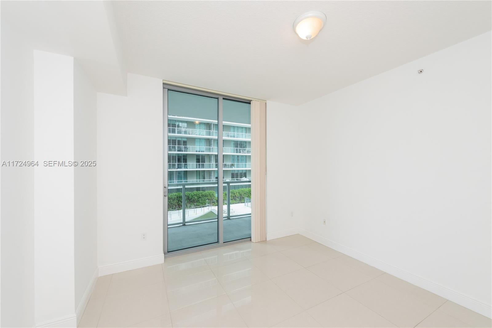 79 Southwest 12th Street, Unit 1107S Miami, FL 33130 - Photo 17 of 26 a view of an empty room with a window