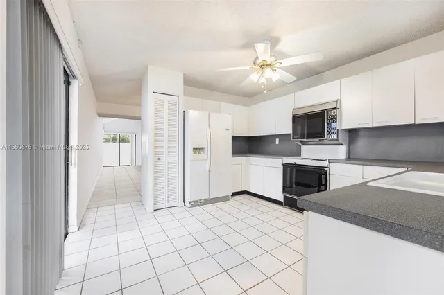 a kitchen with a stove a sink and a refrigerator