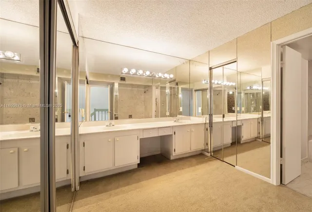 a large bathroom with a large mirror vanity and sink