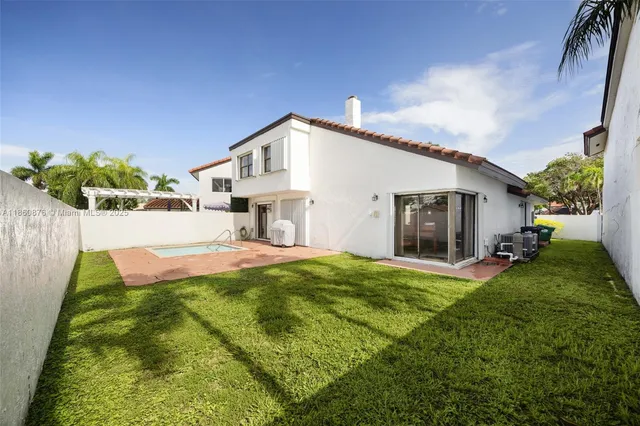 a view of a house with backyard and porch