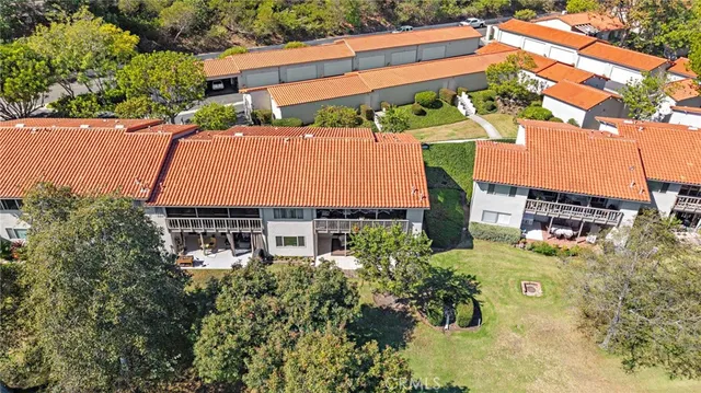 an aerial view of a house with yard swimming pool and outdoor seating