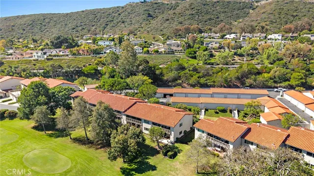 an aerial view of residential houses with outdoor space and street view