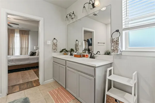 a bedroom with a bed and dresser with mirror