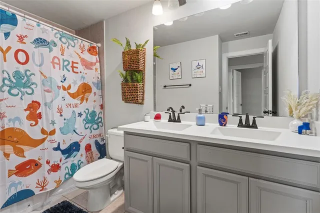 a living room with furniture and a ceiling fan