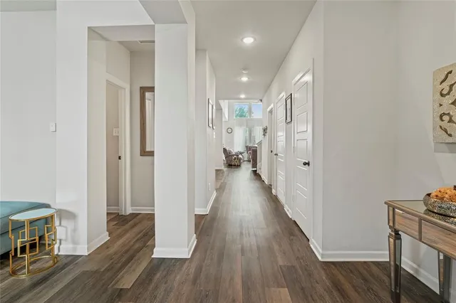 a view of a hallway with wooden floor
