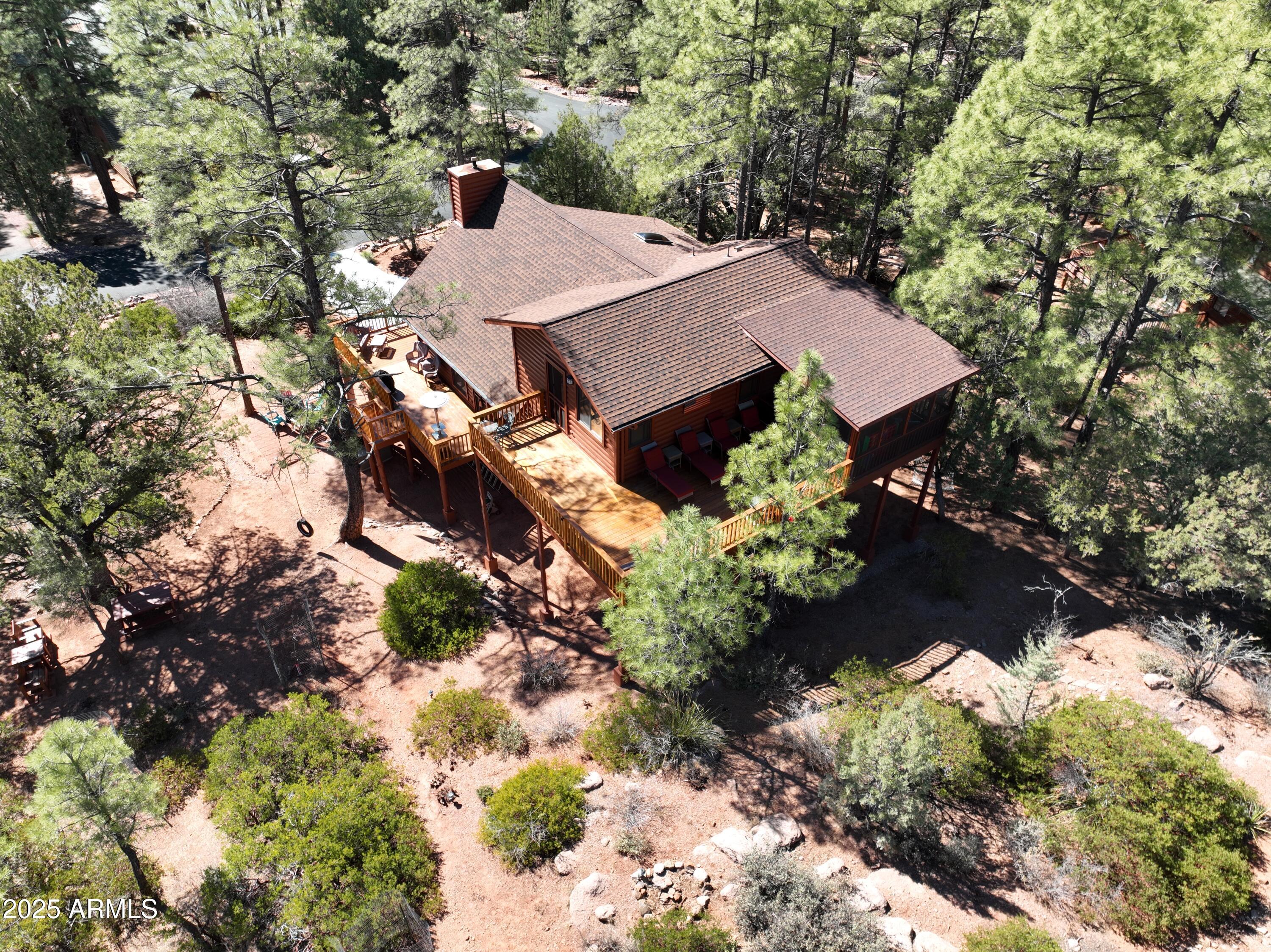5579 Solitude Trail Loop Pine, AZ 85544 - Photo 42 of 50 a view of a big house with large trees