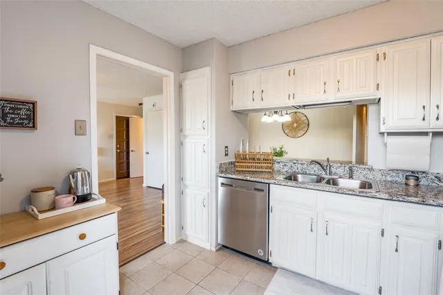a kitchen with cabinets and stainless steel appliances