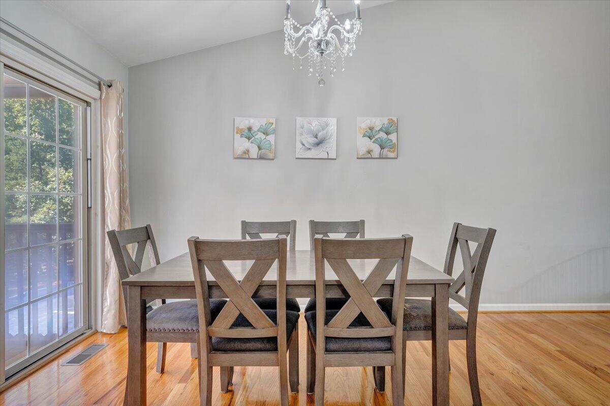 1063 Colony Court Moneta, VA 24121 - Photo 11 of 60 a view of a dining room with furniture a chandelier and wooden floor